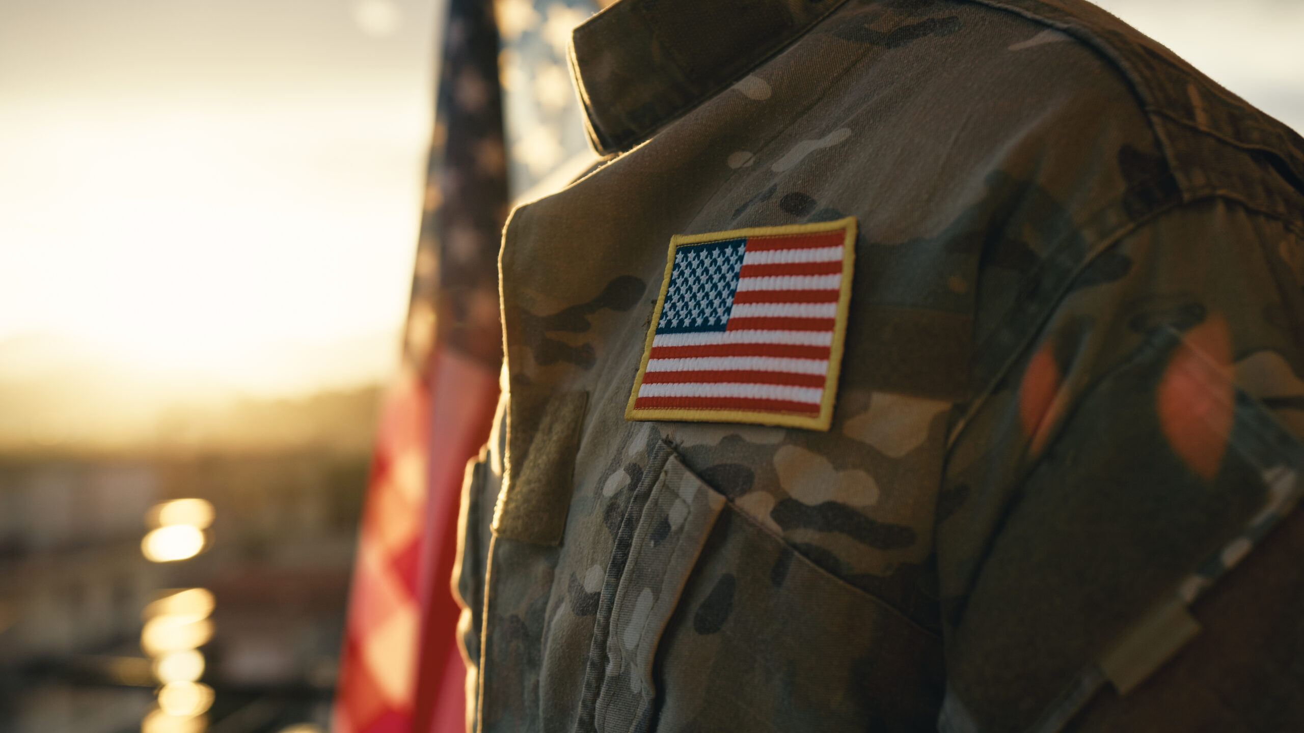 American flag on chest of military man praying for memorial day